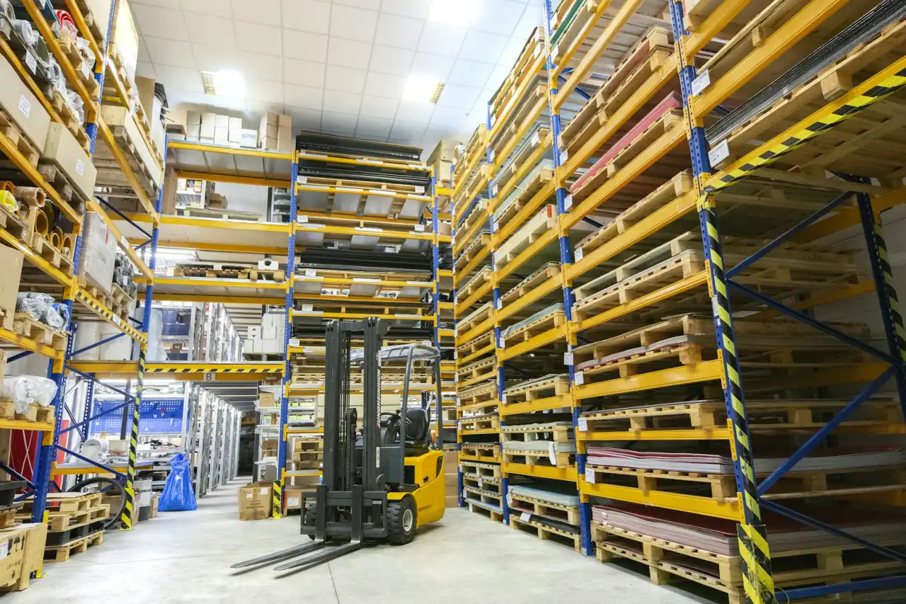 Large warehouse with high racking – the kind of facility we cable with fiber, Cat6 and Wi-Fi